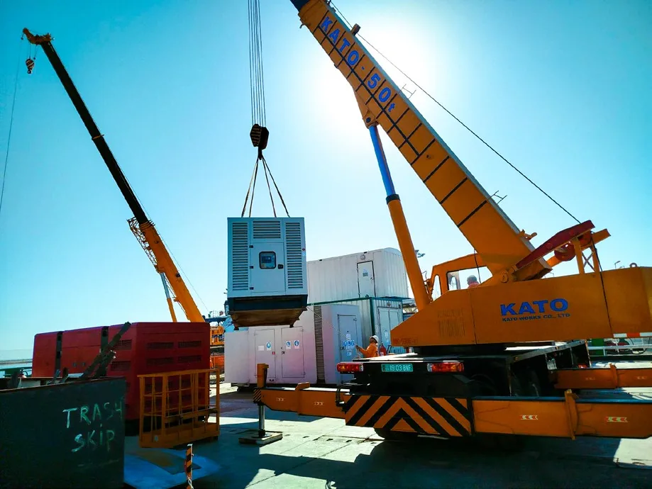 Crane lifting plant equipment into position during LMP construction