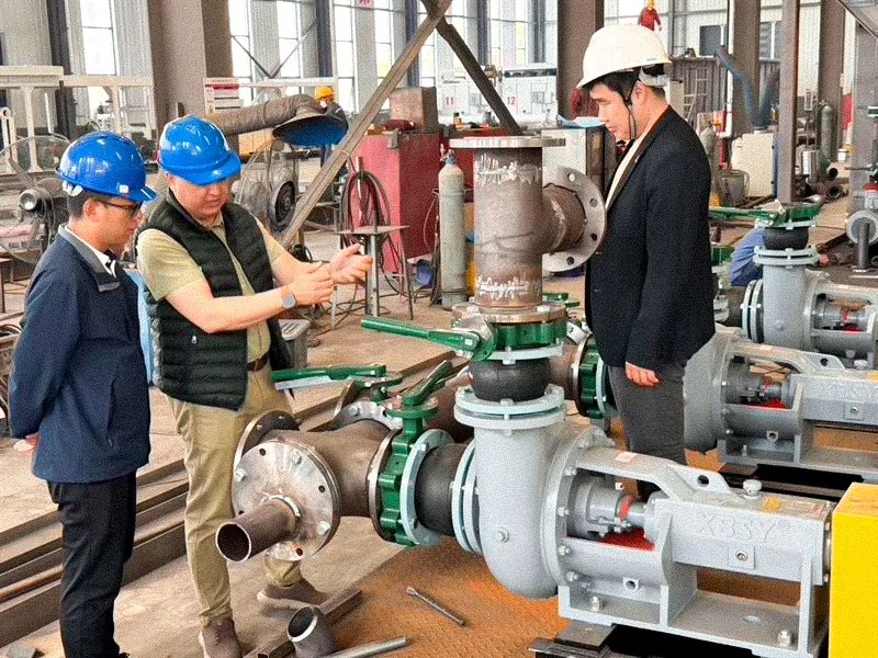 Engineers inspecting valve assemblies in the workshop